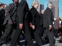 Slow motion medium shot crowd of businesspeople walking back and forth Stock Footage