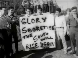 B/W 1950s teen men at demonstration with sign - "Glory, Segretion...KKK" / New Orleans, low angle / newsreel Stock Footage