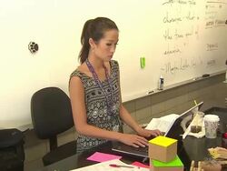 Teacher Typing On Computer In Classroom Stock Footage