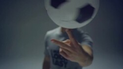 young male soccer freestyler spins a ball on his fingers Stock Footage
