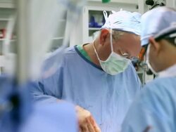 Doctors performing surgery in operating room Stock Footage