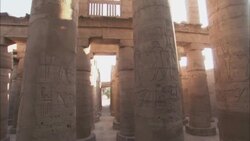 The sun shines on pillars covered with hieroglyphs in an ancient temple. Stock Footage