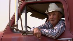 A farmer in a cowboy hat sits in his pickup truck smiling. Stock Footage
