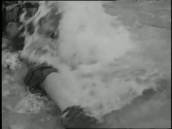 Dead soldiers float in water and lie on shore during the Battle of the Pacific. News Clip