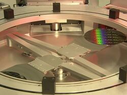 Medium static - An etcher moves a disk through different slots in a photolithography room /   Stock Footage