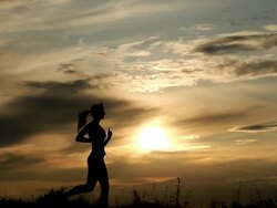Woman Running against sunset Stock Footage