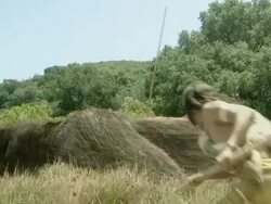 Medium Long Shot static - A prehistoric man hunts a mammoth. / Dallas, Texas, USA Stock Footage