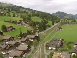 MS AERIAL Shot of village of schonried and hamlet of moos in saanenland region / Schonried, Bern, Switzerland Stock Footage