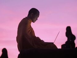WS, PAN A Buddhist monk uses a laptop computer on top of an ancient temple at sunrise in Angkor Wat / Siem Reap, Cambodia Stock Footage