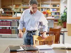 MS Shot of man studying in library / Santa Fe, New Mexico, United States Stock Footage