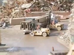 CAT machines move heavy metal items using forklifts Stock Footage
