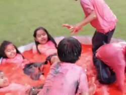 Group of kids playing holi festival in a lawn  Stock Footage