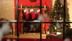 Christmas stocking fireplace scene looking through window - Snow falling Stock Footage
