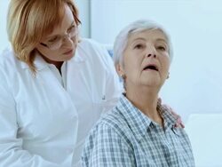 Female doctor checking the senior womans back for irregularities Stock Footage