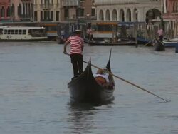 WS LD Gondolier Rowing Gondola down Grand Canal / Venice, Italy Stock Footage