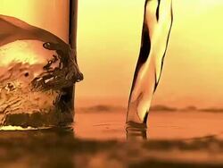 CU SLO MO Shot of water being poured near glass with Ice Cube / Vieux Pont en Auge, Normandy, France Stock Footage