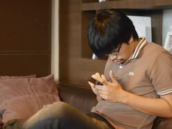 side view : young adult play phone Stock Footage