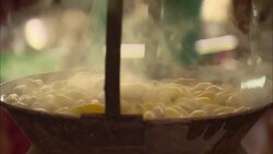Steam rises from a small kettle of silk cocoons. Stock Footage