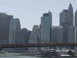 MS Brooklyn Bridge traffic with South Street Seaport in BG  / New York, New York, USA Stock Footage