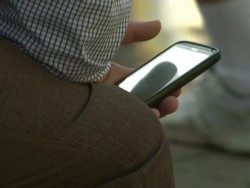 People using mobile phones in the street News Clip