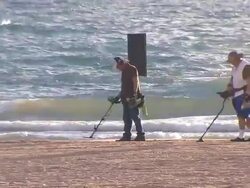 People Using Metal Detectors On The Beach Stock Footage