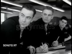 1942: NAVAL RESERVES: Sailors standing at drafting tables. MS Two sailors looking (L, toward blackboard). MERCHANT MARINES: VS Merchant Seaman at hiring hall, standing outside & inside by cashier's cage. Naval Reserves, Hazardous Duty. WWII Instructional Video