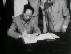B/W 1950s Chairman Mao Zedong sitting at table signing document / newsreel Stock Footage