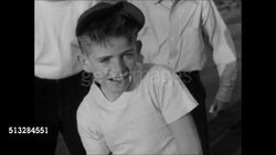 1950: NEIGHBORHOOD BASEBALL GAME: Baseball game in progress, boy running around base & toward home plate, freckled face boy cheering 'yea', boy sliding into home, catcher trying to tag him out. Woman comes to door of house in BG, boys turn. Instructional Video