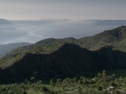 WS POV PAN Hilltop of rugged forested valley and river / India Stock Footage