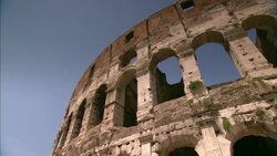 The ruins of the Colosseum contrast against a blue sky. Stock Footage