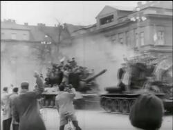 B/W 1956 PAN 2 tanks carrying groups of civillians drive past camera  / Hungarian uprising Stock Footage
