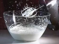 Close Up, Locked Down - An electric mixer whips cream / USA Stock Footage