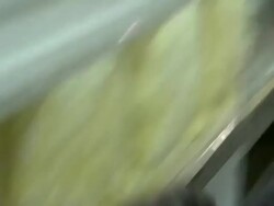 Caucasian fale factory workers affix steel strip to side of RV Stock Footage