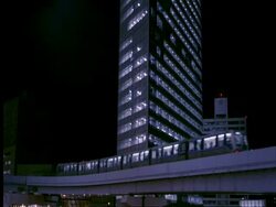 WA modern shiodome buildings, Yurikamome line train moves past, Tokyo, Japan Stock Footage