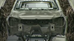 Automated buffers polish a car body in an automotive factory. Stock Footage