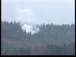 Smoke from the crash scene and rescue workers in the area News Clip