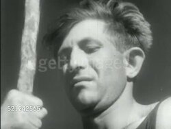 MOT 1938: BRITISH MANDATE PALESTINE: JEWISH COMMUNITY: EXPANSION: VS Jewish men working to clear land, breaking rocks, drilling. Men working on street project, laying stones. Men rolling wheelbarrow down wooden plank construction project walkway. Instructional Video