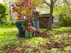 WS DS Grandmother and grandfather with grandson raking leaves / Tivoli, New York, United States Stock Footage