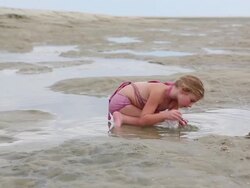 MS Shot of young girl playing in sand at beach / St. Simons Island, Georgia, United States Stock Footage