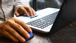 close up hand working on laptop on wood table Stock Footage