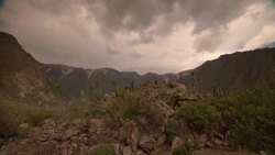 Storm clouds roll above desert mountains. Stock Footage
