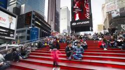 Pedestrians sit on the bleachers situated on 42nd Street in Times Square. Stock Footage