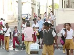 MS Shot of Group of school children crossing street at town / Cuba Stock Footage