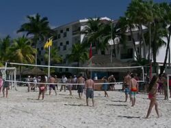 Cancun resort people play volleyball ocean view Stock Footage