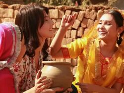 Three young women carrying earthen pot in a village, Haryana, India Stock Footage