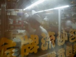 Looking through a window to see traditional Chinese Rice and Dim Sum Steamers being prepared in a busy restaurant kitchen, Central, Hong Kong, China - model and property released -, Time-lapse Stock Footage