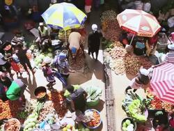 WS HA SLO MO Shot over African market street vendors selling fresh vegetables and fruits / Santiago, Cape Verde Stock Footage