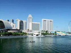 The Esplanade and Marina Bay Buildings with the Singapore Flyer Ferris wheel and River Sightseeing Boat, Singapore Stock Footage