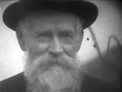 B/W 1900s close up PORTRAIT senior immigrant man with beard + hat smiling / NYC / newsreel Stock Footage