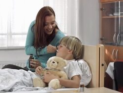 HD DOLLY: Mother Giving Cough Syrup To Her Son Stock Footage